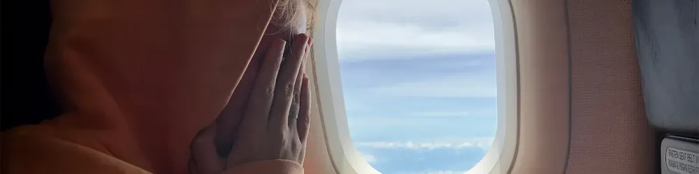 Close up of nervous woman on airplane